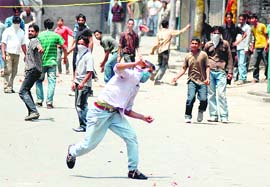 Muslim youths pelt stones at the police during a demonstration in protest against the arrest of a youth in Srinagar on Wednesday. 