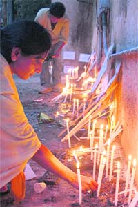 Family members of serial blast victims light candles during a prayer meeting in Ahmedabad
