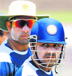 Virender Sehwag (R) walks with teammate V.V.S. Laxman during a practice session at the Galle International Cricket Stadium