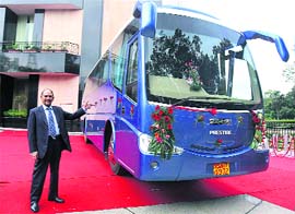 Managing director of Swaraj Mazda, Yash Mahajan with the new ultra luxury 'Swaraj Prestige LT Bus  Powered by Isuzu' at its launch in New Delhi on Thursday.