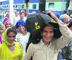Pilgrims arrive at Kurukshetra railway station to take a dip in the holy sarovars in the city on the occasion of the solar eclipse, which will take place on Friday.