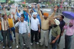 Members of the Punjab Rural Health Coordination Committee hold a protest in support of their demands at BMC Chowk in Jalandhar on Thursday