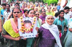 Holding aloft Kuldeep Dogras photograph, women hold a protest march in Jammu on Thursday. 