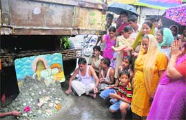 Devotees throng the Shivalingam in Jammu on Thursday.