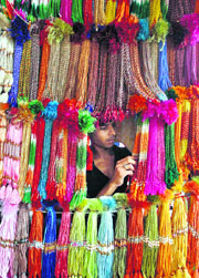 A vendor arranges rakhis at a market in city of Siliguri on Thursday. The festival of Raksha Bandhan will be celebrated across the country on August 16.