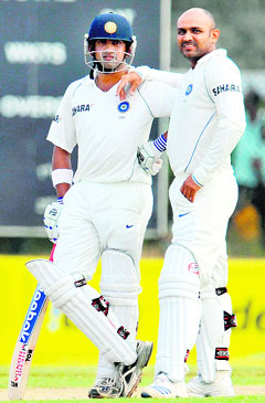 Gautam Gambhir (L) and Virender Sehwag wait for a decision from the third umpire during the first day of the second Test match between India and Sri Lanka at The Galle International Cricket Stadium in Galle on Thursday.