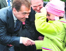 Russian President Dmitry Medvedev shakes hands with a little girl in Gagarin on Thursday.