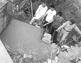 The gutter in Mohali being covered by MC officials in which Sukhwinder Singh fell and died in the PGI, Chandigarh.