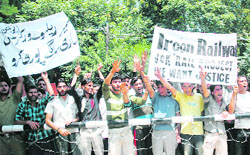 Employees of the Ircon rail project hold a demonstration in support of their demands in Srinagar