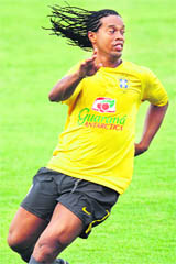 Brazilian star soccer player Ronaldinho warms up during a training session at Hanoi's My Dinh stadium on Friday.