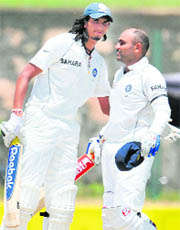 Virender Sehwag being congratulated by teammate Ishant Sharma after completing a double century during the second day of the second Test match between India and Sri Lanka at The Galle International Cricket Stadium in Galle on Friday.