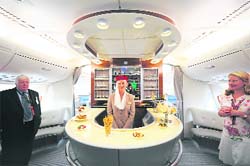 A flight attendant gives a tour to journalists in the business class lounge aboard an Emirates Airline A380 on Friday. The A380 is the worlds largest airliner with 49 per cent more floor space and 35 per cent more seating than the previous largest aircraft.