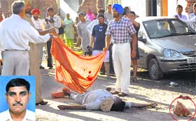 Policemen cover the body of inspector Kashmir Singh (inset) in a Dadumajra colony, Chandigarh