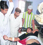 An injured of the firing incident at the district courts being treated in the Civil Hospital at Moga