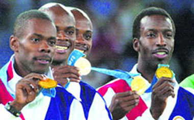 This file picture taken on September 30, 2000 during the Sydney 2000 Olympic Games shows US gold medallists (L to R) Antonio Pettigrew, twin brothers Calvin and Alvin Harrison and Michael Johnson celebrating with their medals on the podium of the 4x400m relay final. The IOC has stripped the United States' 4x400-metre men's relay team of the gold medal it won at the Sydney 2000 Olympics for doping. 