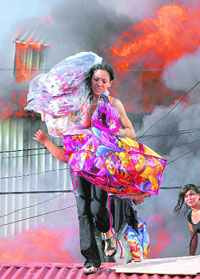 A woman salvages goods from a fire at the Oriental Market, considered to be the biggest in Central America, in Managua on Friday.