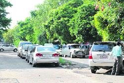 Cars being parked in the backyard of the Sector-28 motor market in Chandigarh on Sunday. 