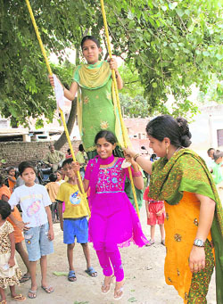 Girls enjoy the swings during Teej celebrations organised by the Sewa Bharti in Karnal on Sunday. 