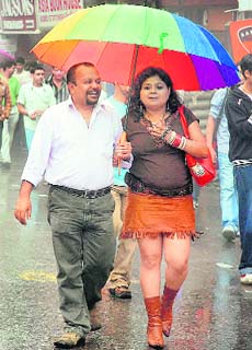 A couple enjoys the weather as the state capital experiences light showers