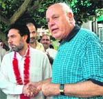 National Conference patron Farooq Abdullah welcomes senior PDP leader Bilal Lodhi and six municipal councillors into the party in Srinagar on Sunday.