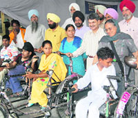 Physically challenged children with the tricycles provided to them at a camp organised by the All-India Pingalwara Charitable Society in Amritsar