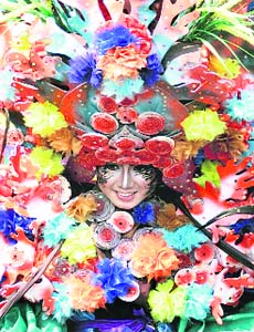 A woman dressed in costume participates in the 7th Jember Fashion Carnival in Jember, East Java