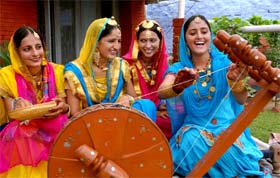 Girls perform at the charkha competition during the Teej festival organised at Swami Vivekananda Girls College in Bathinda