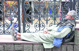 Hard labour induces great sleep. A labourer takes a nap after a gruelling routine on The Mall in Shimla on Monday.