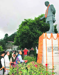 Chief Minister Prem Kumar Dhumal offers floral tributes to late Dr Y.S. Parmar, first Chief Minister of the state, on his 102nd birth anniversary in Shimla on Monday.
