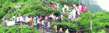 Devotees walk downhill after offering prayers at the Naina Devi shrine temple at Bilaspur on Monday