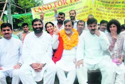 Panthers chief Bhim Singh (garlanded) displays the victory sign after sitting on an indefinite fast in Jammu on Monday.