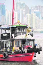 A tourist boat is seen along Victoria Harbour in Hong Kong on Monday ahead of the Beijing 2008 Olympic Games. The equestrian events for the 2008 Beijing Olympic Games will be held in Hong Kong's sweltering heat and the German Animal Defence Association fear for the animals' lives. 