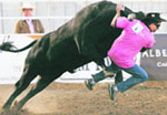 Dave Schareck gets thrown by a rodeo bull in the annual Running With The Bulls during the Strathmore Heritage Days Stampede in Strathmore, Alberta, on Sunday. The annual Canadian event lets people run with wild rodeo and Mexican fighting bulls. 