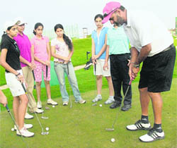 The region's only Grade A golf coach Jessie Grewal gives tips to trainees at an advanced golf camp at the CGA Golf Range in Chandigarh on Tuesday.