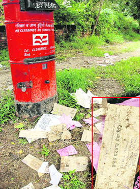 Letters lie scattered in front of a post box on the road separating Sectors 18 and 19