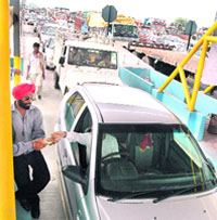 A long queue of vehicles at the newly constructed toll plaza at Satluj Bridge on Tuesday. 
