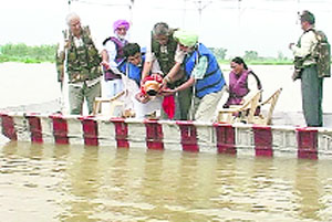 Members of the family of CPM veteran Harkishan Singh Surjeet immerse his ashes in the Sutlej at Hussainiwala on the Indo-Pak border in Ferozepur district on Tuesday.