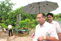Officials of the MC supervise the installation of a pump near the houses of High Court judges in Sector 24, Chandigarh, on Wednesday.