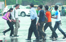 People caught in the heavy downpour on Wednesday afternoon in New Delhi. 