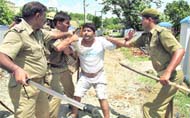 a protester is roughed up by policemen at Nagrota on the outskirts of Jammu.