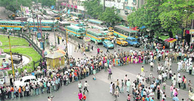 Members of the students wing of the Congress form a human chain to block a road during a protest demonstration against the state government in Kolkata on Wednesday