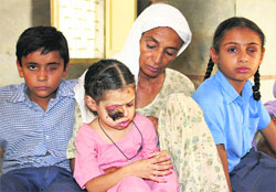 Nasseb Kaur with her grandchildren at Gehri Devi Mandir village in Bathinda