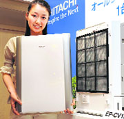 A Hitachi employee displays the new high-performance air purifier "Cleair", equipped with various sensors of dust, odour, humidity and temperature that enables to purify air, deodorise, humidify in Tokyo on Thursday.