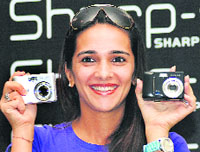 Bollywood actress Tara Sharma poses with Sharps newly launched digital cameras in New Delhi on Thursday.