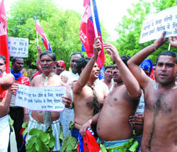 Activists of The Indian Justice Party (IJP) hold a semi-nude protest against the hike in the prices of day-to-day commodities in New Delhi on Thursday. 