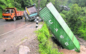 Due to heavy rain, an overloaded trolley falls into a nullah near Parwanoo on the Panchkula-Shimla highway on Thursday.