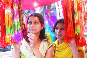 Young girls shop for rakhis in Jalandhar on Thursday. The festival is scheduled for August 16. 
