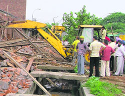 Illegal shops being razed in Transport Nagar in Ludhiana on Thursday.