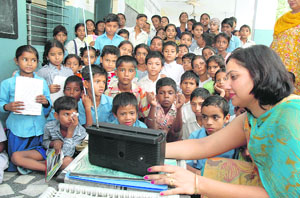 A teacher of Government Primary School checks the frequency of a radio set in Ludhiana on Thursday. 
