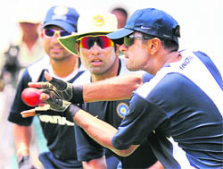 Rahul Dravid (R) is watched by teammates V.V.S. Laxman and Sachin Tendulkar (L) as he catches a ball during a practice session at The P. Saravanamuttu Stadium in Colombo on Thursday. 